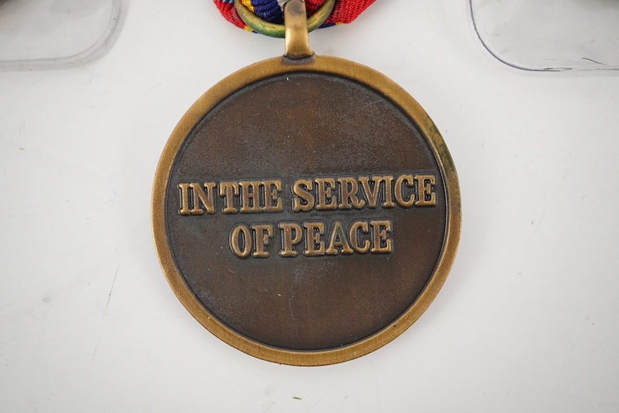 Thirteen United Nations (UN) and NATO medals, eleven UN examples with ‘ in the service of peace’ to the reverse, including a variety of ribbons for a number of different campaigns, (some duplicates), and two NATO ISAF Af